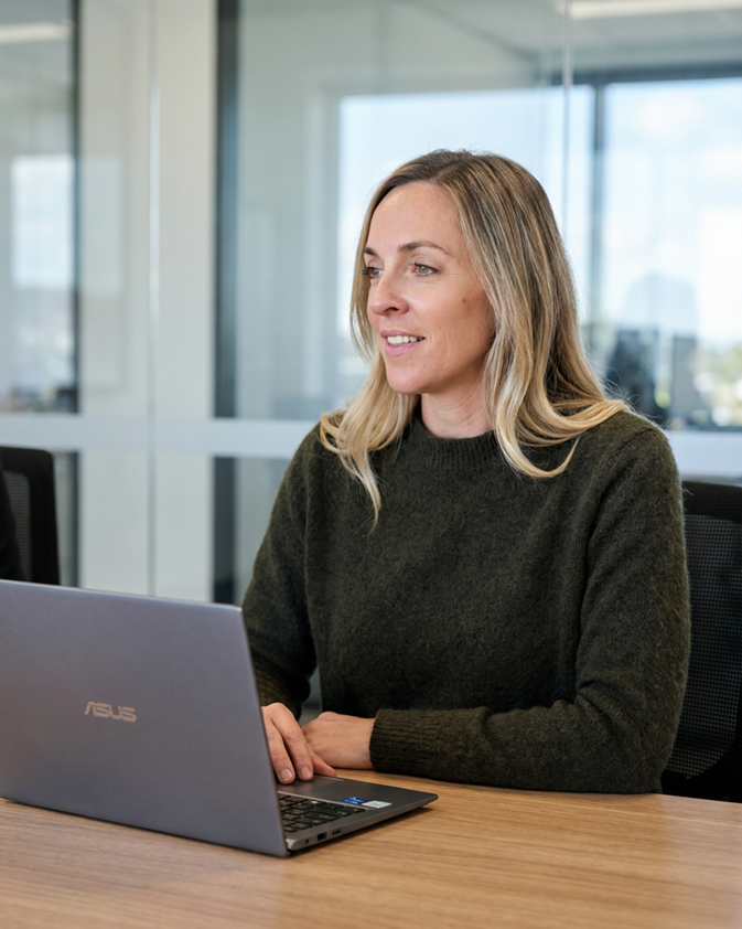 Caroline, founder of Marcx, working at a laptop